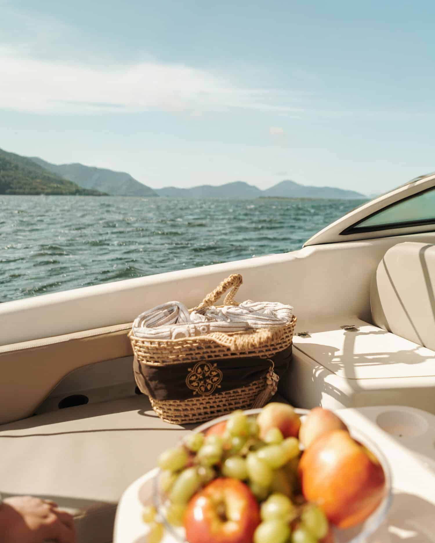 Picnic basket with a fruit plate on a boat 